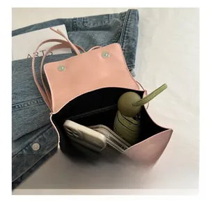Interior view of pink flap backpack showing phone, wallet, and folding umbrella capacity