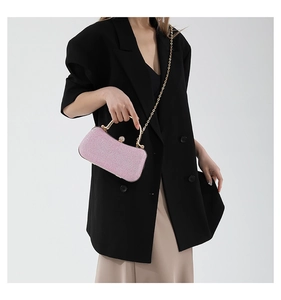 Elegant pink glitter evening bag featuring a gold metal handle and chain strap for women
