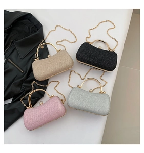 Detail of luxury glitter evening clutch bags with gold metal handles and chain straps