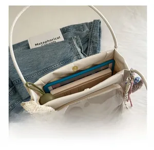 White leather tote bag interior view showing large capacity for tablets and books