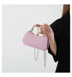 Detailed shot of pink glitter evening bag with gold handle and delicate chain strap