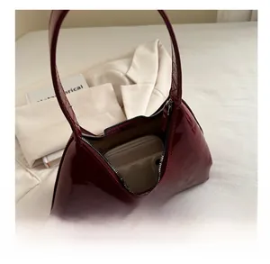 Interior view showing the capacity of a wine red patent leather baguette shoulder bag