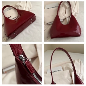 Detail view of burgundy patent leather bag showing glossy texture and silver rivets