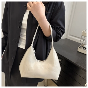 Detail of white patent leather hobo bag with smooth finish and Baload Cult logo print