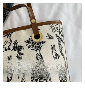 Detail of Chinese style embroidery on tote bag with leather handle and golden buckle