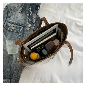 Macro shot of brown leather tote bag interior with large capacity and zipper pocket
