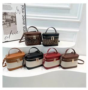 Detail of vintage box-style handbags in diverse colorways and leopard print textures