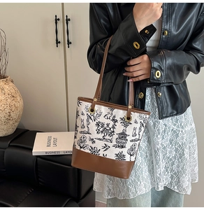 Detail of vintage tote bag featuring Chinese landscape prints and leather stitching accents