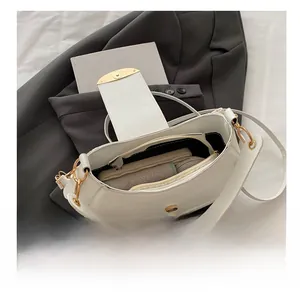 Detailed view of the large capacity interior of the white crescent shoulder bag