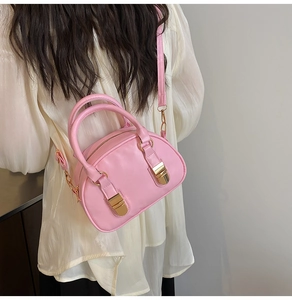 Pink Boston style crossbody bag shown on model for size reference and sweet style