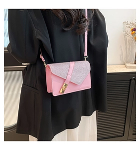 Detail of pink glitter flap shoulder bag with gold rectangular clasp on model side view