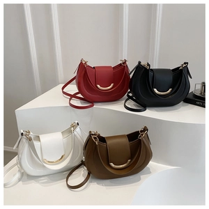 Detailed display of half-moon leather shoulder bags in four colors with gold crescent buckles