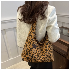 Detailed view of leopard print corduroy fabric texture with a black Fashion patch