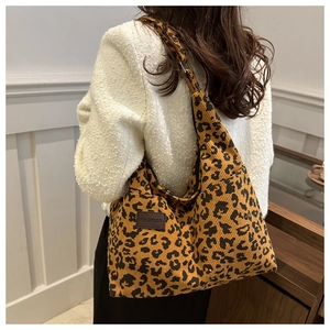 Detail of leopard print corduroy tote bag showing the textured fabric and FASHION label