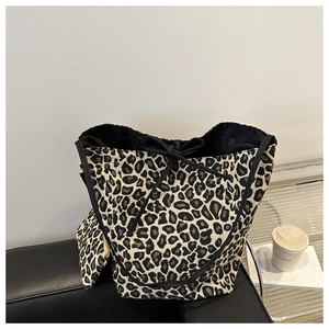 Detail of leopard print tote bag with black bow tie and matching small pouch