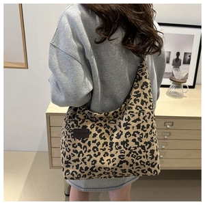 Detailed texture of leopard print corduroy tote bag with fashion leather patch
