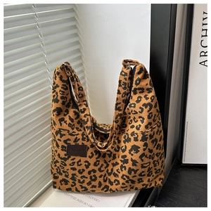 Detail of the corduroy leopard print tote bag with a leather fashion patch on the side