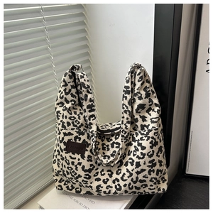 Detail of leopard print corduroy tote bag showing the texture and leather FASHION patch