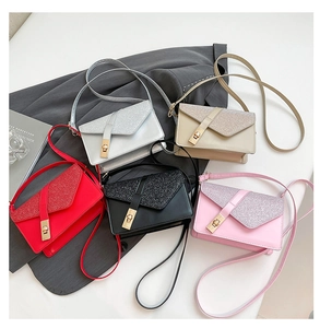 Detail view of five sequined flap crossbody bags in silver, apricot, red, black, and pink