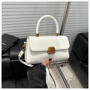 Detail of white vintage leather handbag showing the elegant gold square metal buckle lock