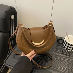 Deep brown crescent shoulder bag with vintage gold metal clasp and adjustable strap