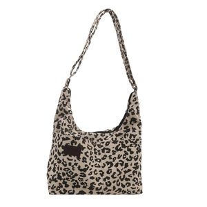 Large leopard print corduroy tote bag with front pocket and shoulder straps on white background