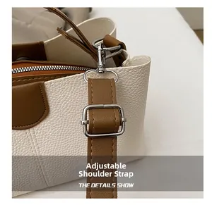 Detail of adjustable shoulder strap with silver hardware on lychee leather handbag