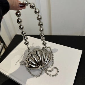 Silver shell-shaped evening clutch bag with beaded chain handles and luxury metallic finish