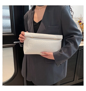 Detailed close-up of a white woven PU leather clutch with gold buttons on the flap