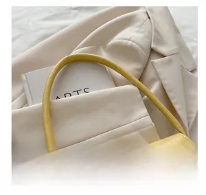 Gros plan sur le sac baguette jaune avec texture crocodile et boucle en métal