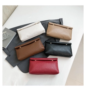Detail of woven texture faux leather clutch bags in five colors with gold buckles