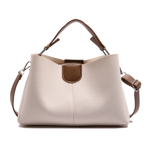 Off-white and brown bucket bag with lychee texture and adjustable leather strap