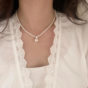 French vintage pearl necklace with a sparkling single diamond pendant for women
