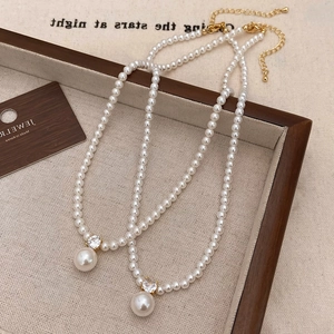 French vintage pearl necklace with a sparkling zircon pendant and golden clasp