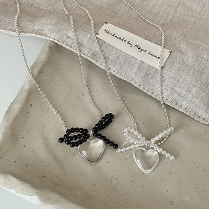 Chic transparent heart pendant necklaces with black and white bow details in beaded silver