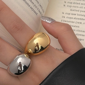 Minimalist oversized two-tone egg-shaped ring in polished gold and silver finish