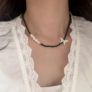 Détail du collier de perles en spinelle noir, perles d'eau douce et papillon en nacre
