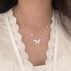 Elegant beaded necklace featuring a hollow butterfly pendant and translucent crystal beads