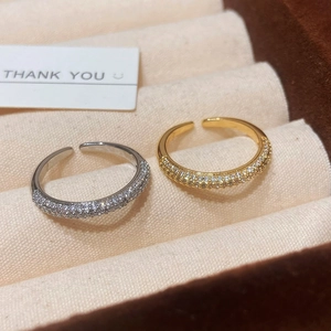 Pave-set zircon adjustable open rings in gold and silver finish on jewelry box