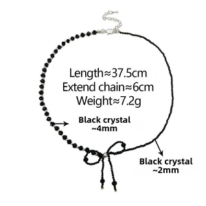 Macro shot of asymmetric black crystal beaded choker with woven bow detail and silver clasp