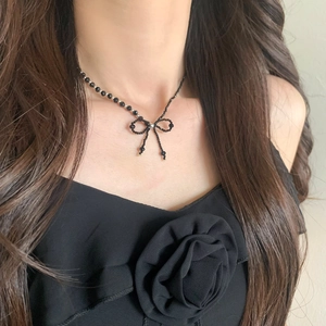 Elegant black beaded bow necklace featuring spinel crystals in a vintage choker style