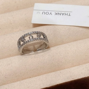 Close-up of silver hollow ring with double-row micro-set zircons in a jewelry box