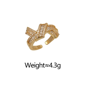 Detailed view of adjustable gold ribbon ring set with sparkling zircon stones