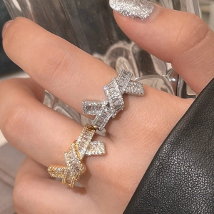 Close-up of sparkling gold and silver bow-knot rings with stacked zircon stones
