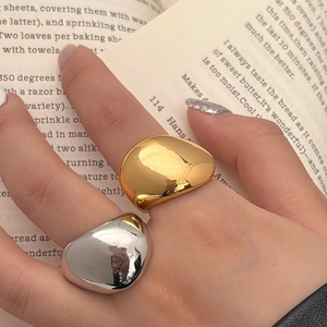 Minimalist gold and silver water drop rings with a polished finish and modern design