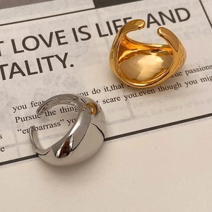 Minimalist teardrop rings in gold and silver set with wide lava texture and polished finish