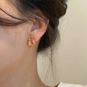 Elegant gold huggie hoop earrings with polished finish and micro-pave crystals