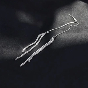 Sparkling silver long fringe tassel threader earrings shown on black silk fabric