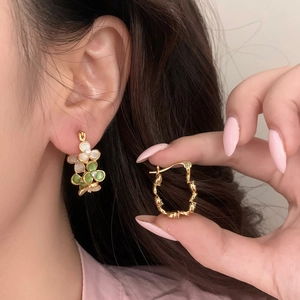 Boucles d'oreilles élégantes à fleurs dorées avec pétales verts et zircons