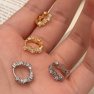 Exquisite Creolen Set in Gold und Silber mit Zirkonsteinen auf der Handfläche